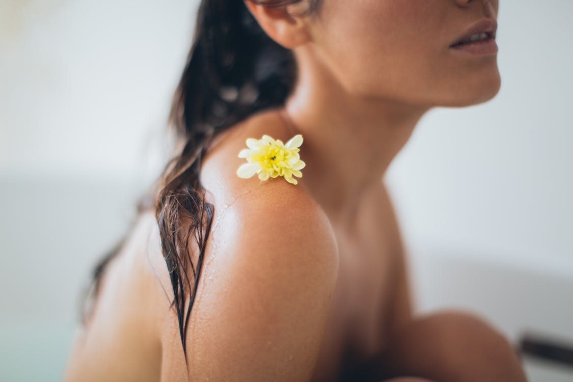 Free woman with white flower on her shoulder stock photo