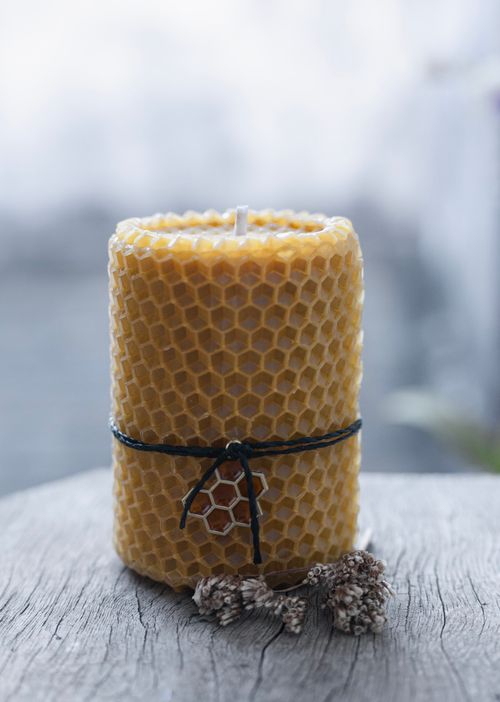 Free Close-up of a handmade beeswax candle with decorative string, showcasing natural beauty and craftsmanship. Stock Photo