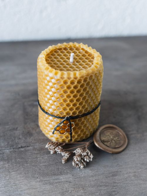 Free A close-up of a handmade beeswax candle on a wooden surface with decorative elements. Stock Photo