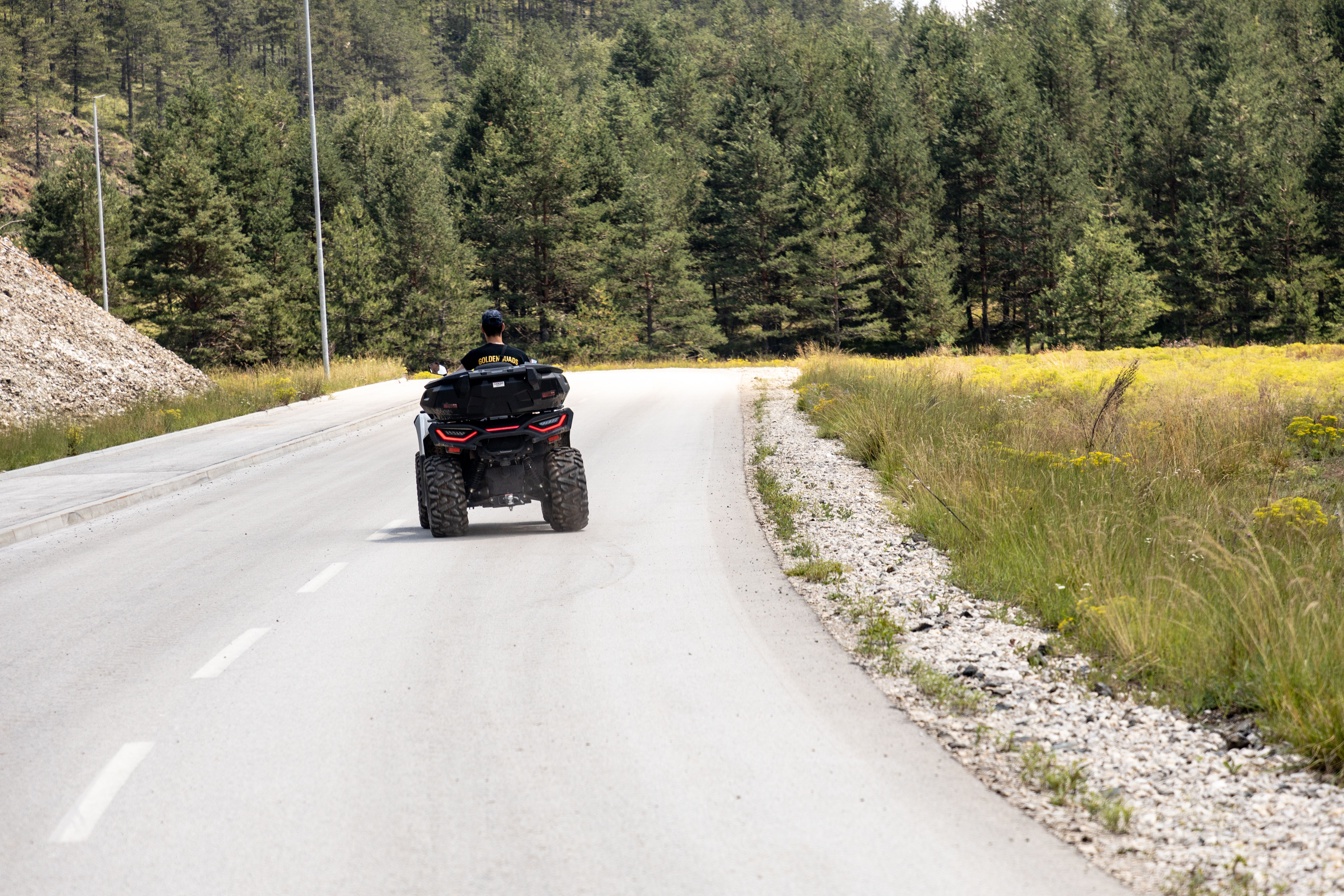 Experience thrilling ATV riding on a tranquil road surrounded by nature in Zlatibor, Serbia.