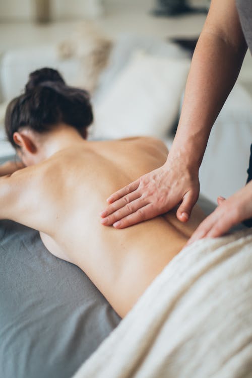 Free Topless Woman Lying on Bed For A Massage Stock Photo