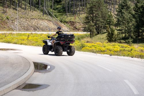 Free A person enjoying an ATV ride along a scenic road in Zlatibor, Serbia, amidst lush greenery. Stock Photo