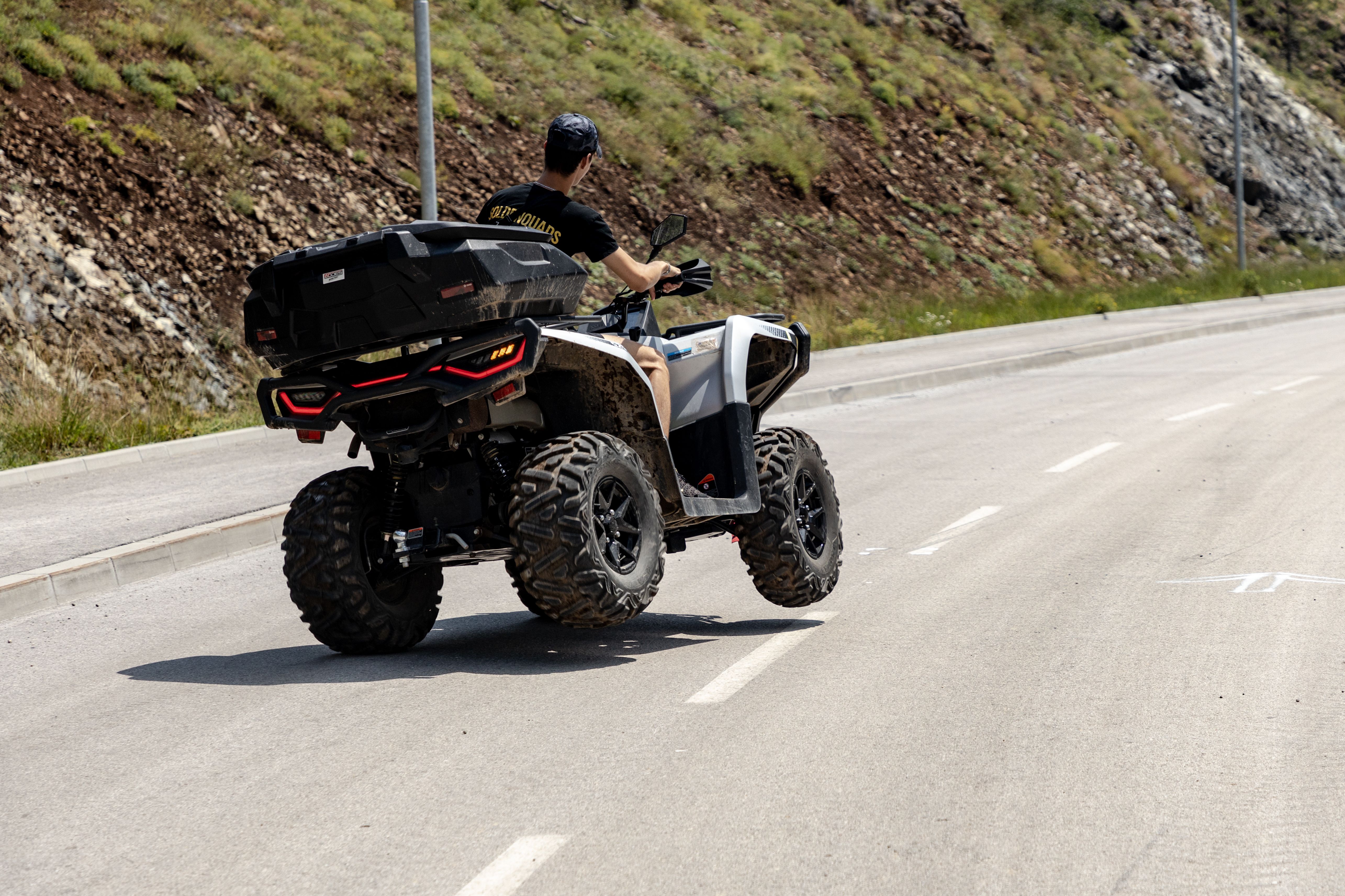 A person riding an ATV on an open road in Zlatibor, Serbia, showing the thrill of outdoor exploration.