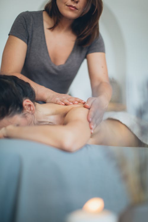 Masseur doing massage to relaxing client