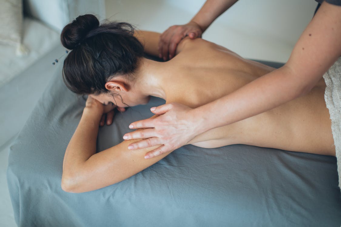 Topless Woman Lying on Bed