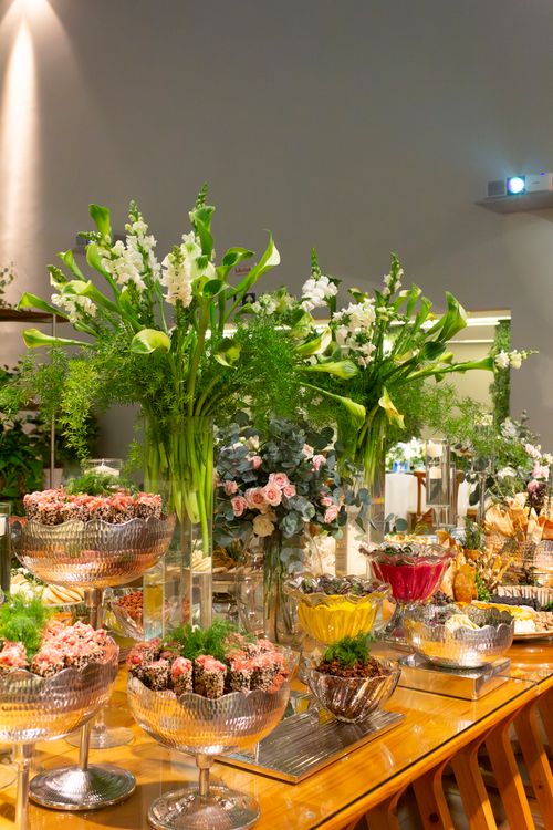 Free Beautifully decorated wedding reception table with lush floral arrangements and desserts in São Paulo, Brazil. Stock Photo