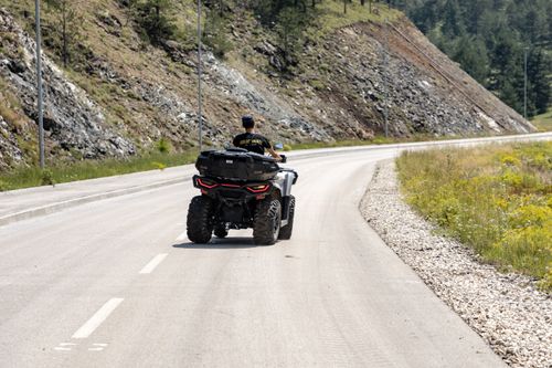 Free A quad biker enjoys a scenic ride on a winding mountain road in Zlatibor, Serbia. Stock Photo