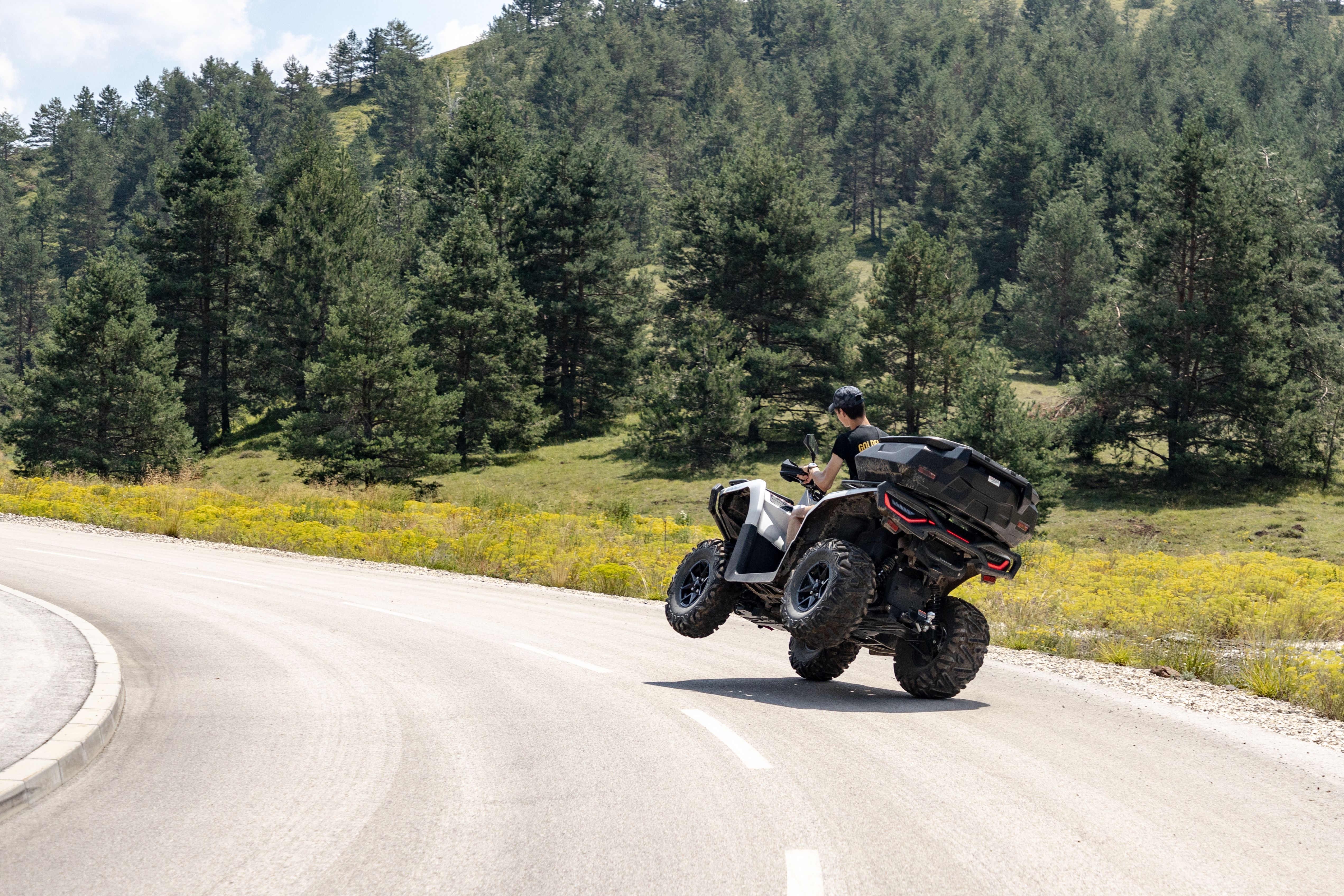 Dynamic shot of an ATV on a winding road in Zlatibor, showcasing outdoor adventure and nature.