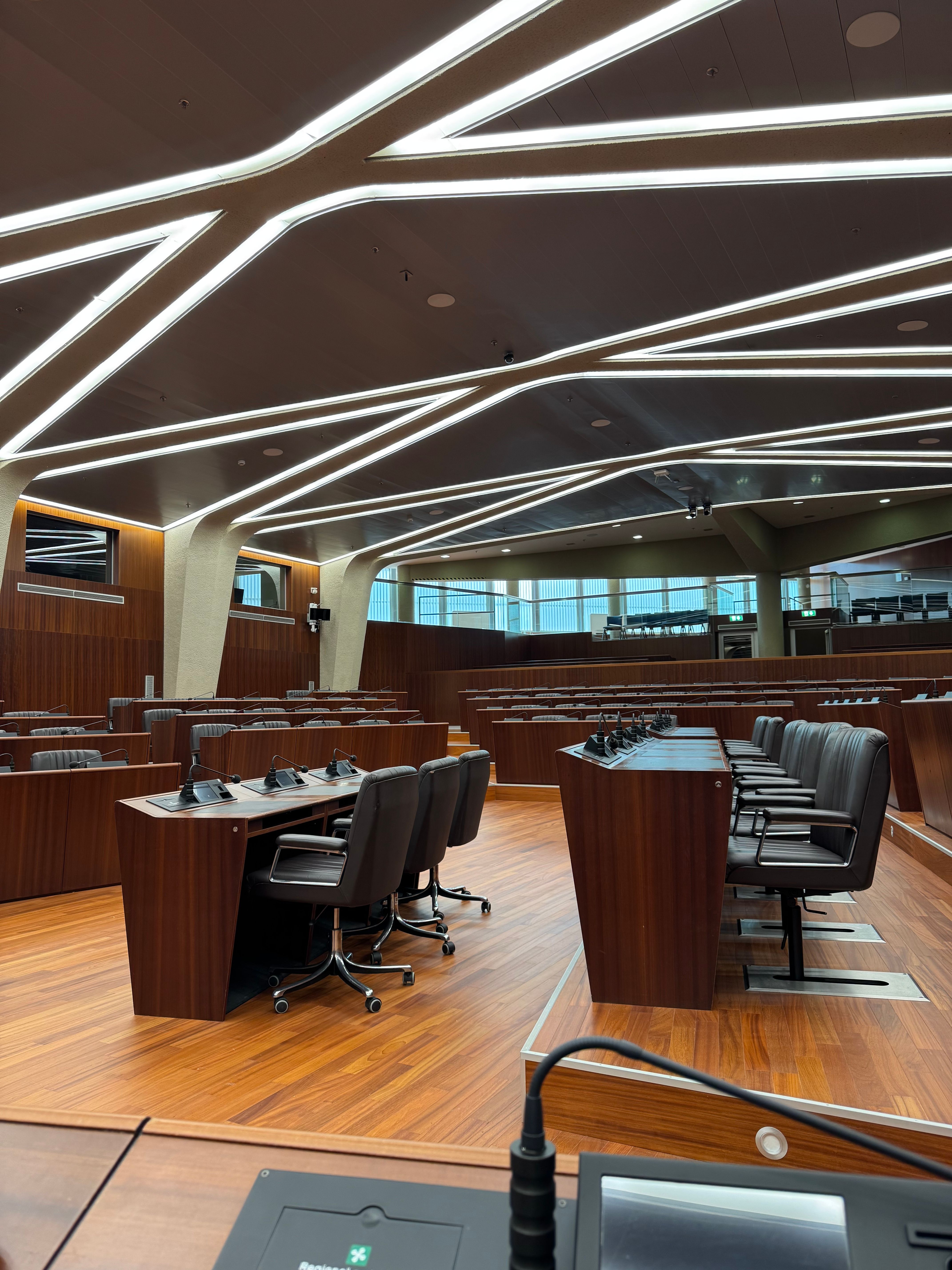 Sleek, modern conference room with wooden paneling and unique lighting in Milano, Italy.