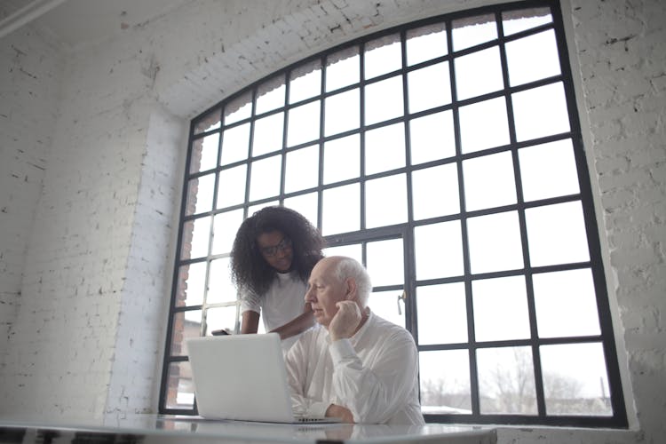 Concentrated Diverse Coworkers Of Different Age Working Together With Gadgets