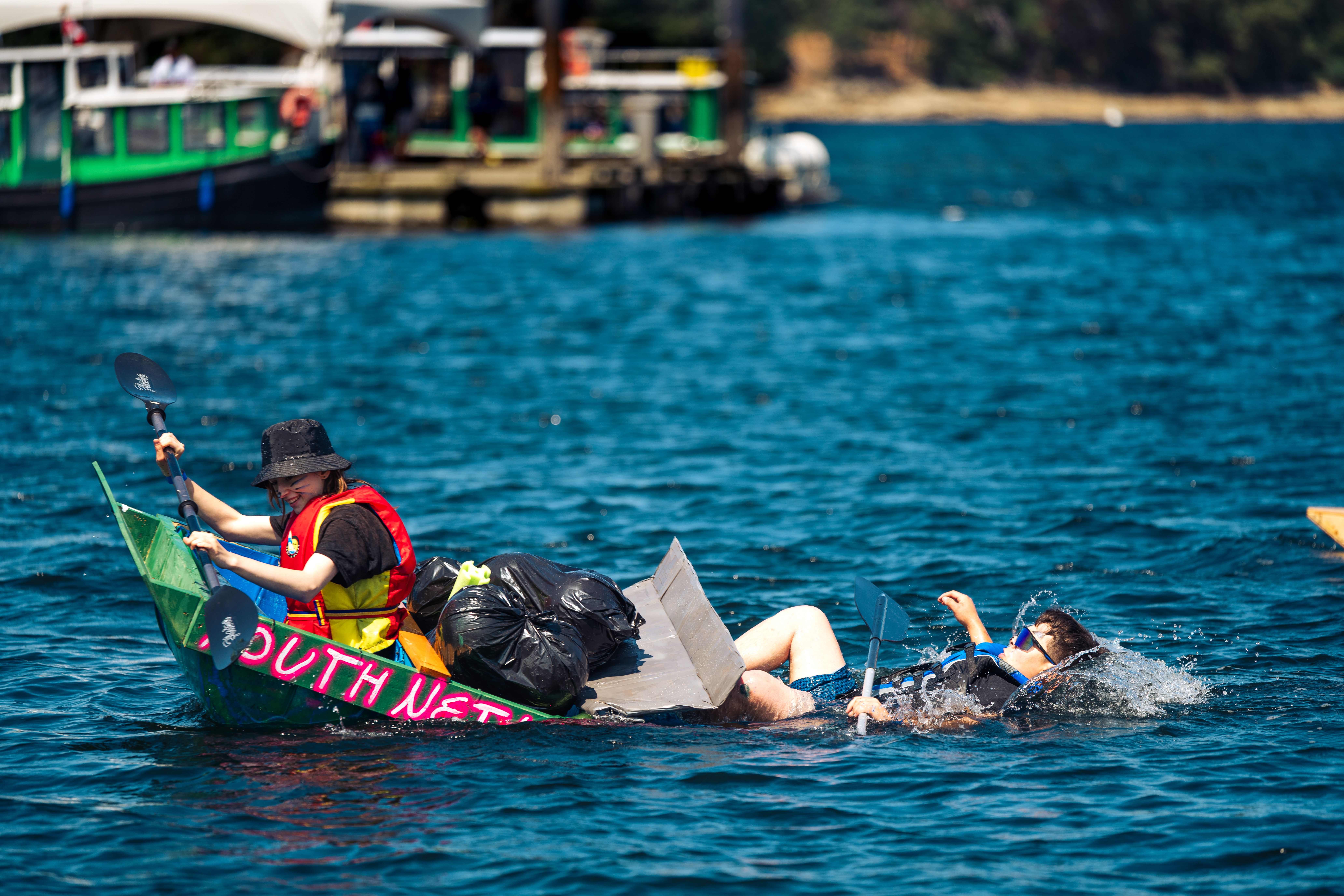 Participants in a makeshift boat at Nanaimo's Silly Boat Regatta, British Columbia.