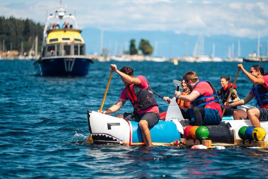Racers paddle a themed raft in Nanaimo's vibrant Silly Boat Regatta event.