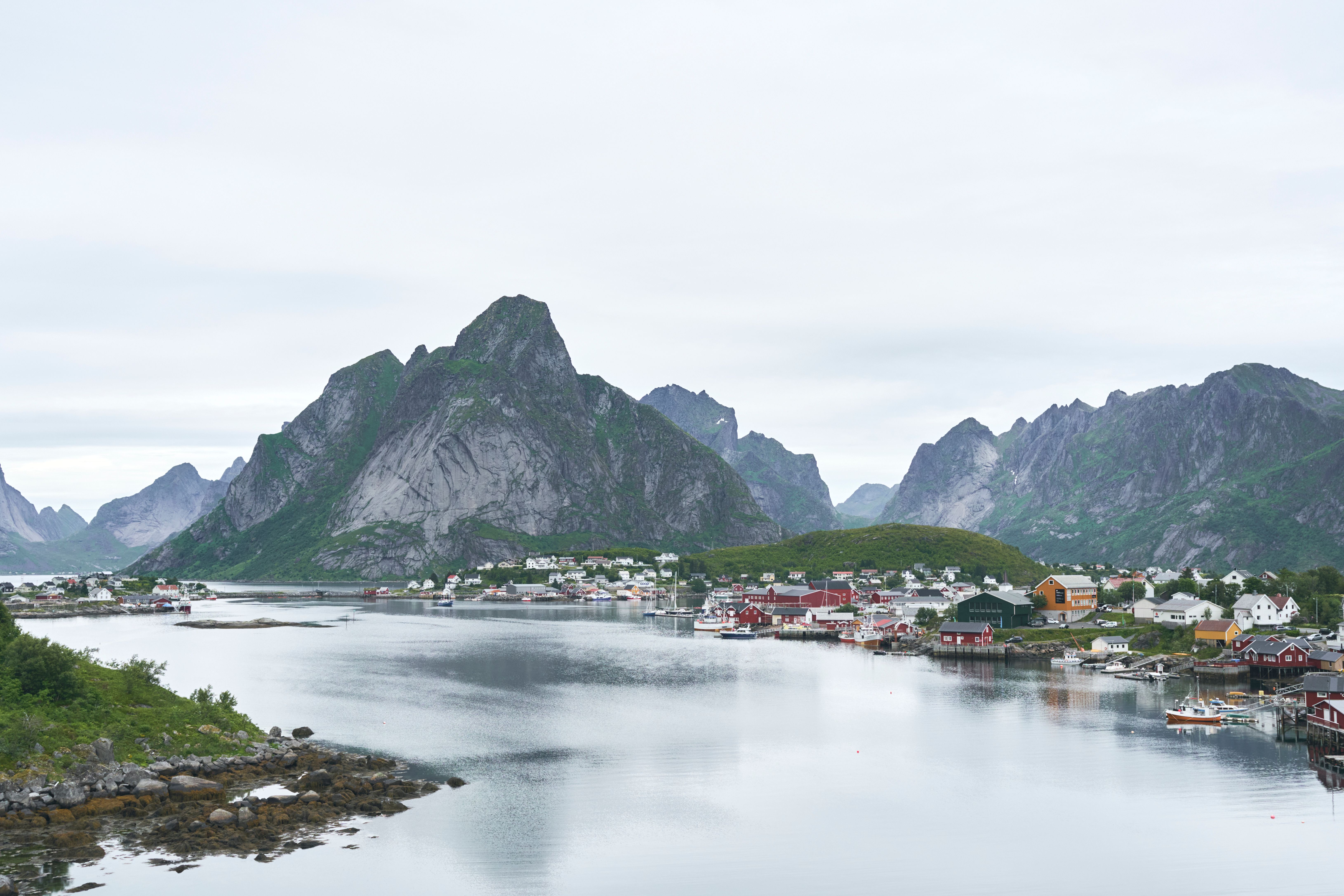 Picturesque landscape of Reine, Lofoten Islands, featuring dramatic mountains and colorful houses by the water. - Lofoten