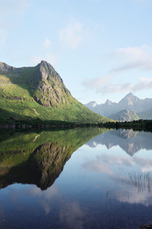 Free A tranquil mountain scene with clear lake reflections under a bright sky. Stock Photo