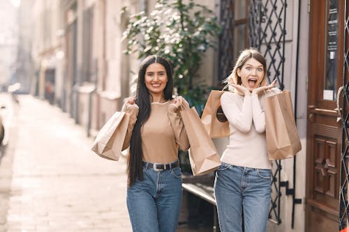 Cheerful friends having fun after shopping