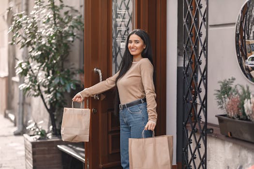 Happy woman leaving a store with shopping bags in hand, enjoying a sunny day.