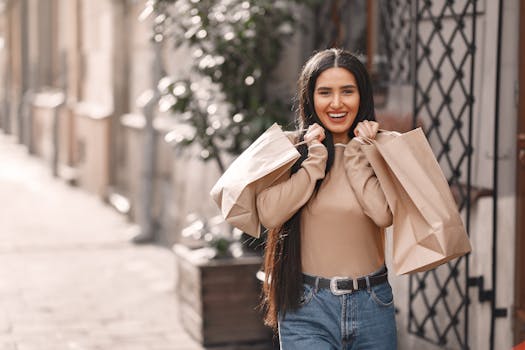 Cheerful young woman with shopping bags enjoying a sunny day outdoors.