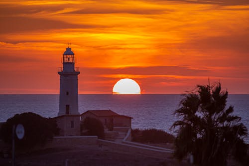 White Concrete Lighthouse During Sunset