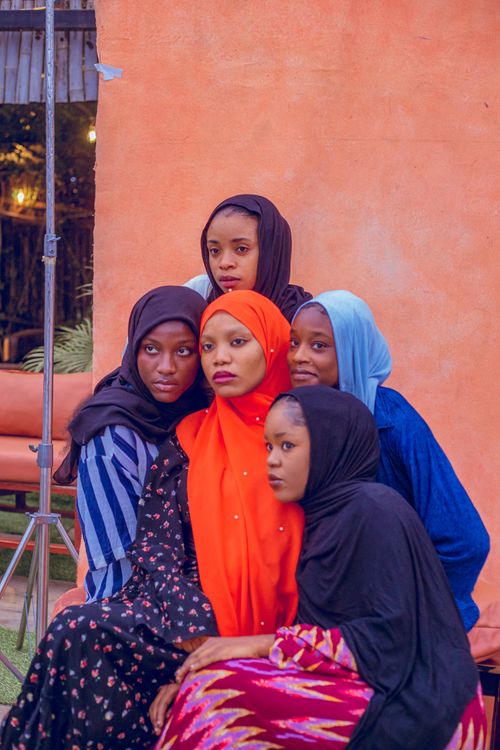 Free A group of smiling women in colorful hijabs posing outdoors in Nigeria Stock Photo