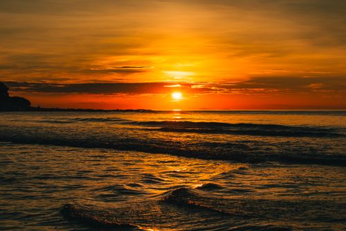 Free Stunning sunset over the ocean captured at Quảng Trị, Vietnam, with vivid orange hues reflecting on the water. Stock Photo