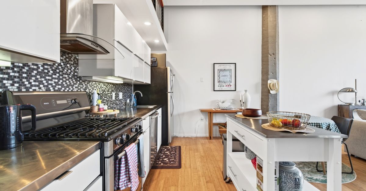 Luxurious industrial-style kitchen in a Boston apartment with contemporary and sleek designs.