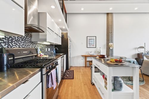 Free Luxurious industrial-style kitchen in a Boston apartment with contemporary and sleek designs. Stock Photo