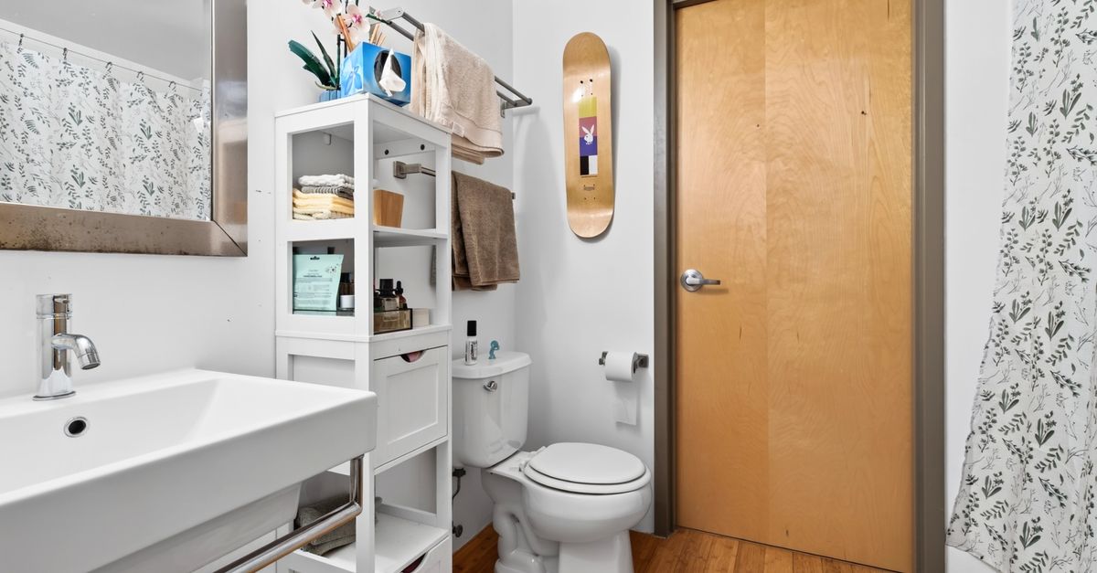 A stylish and organized bathroom interior in a Boston apartment with contemporary fixtures.