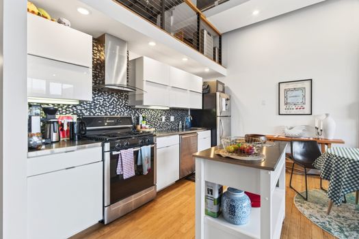 Spacious modern kitchen with sleek design and amenities in a Boston luxury apartment.