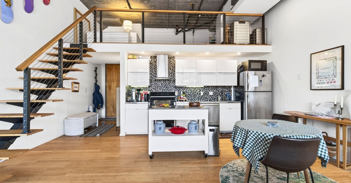 Spacious and stylish loft apartment in Boston, featuring a modern kitchen and unique industrial design.