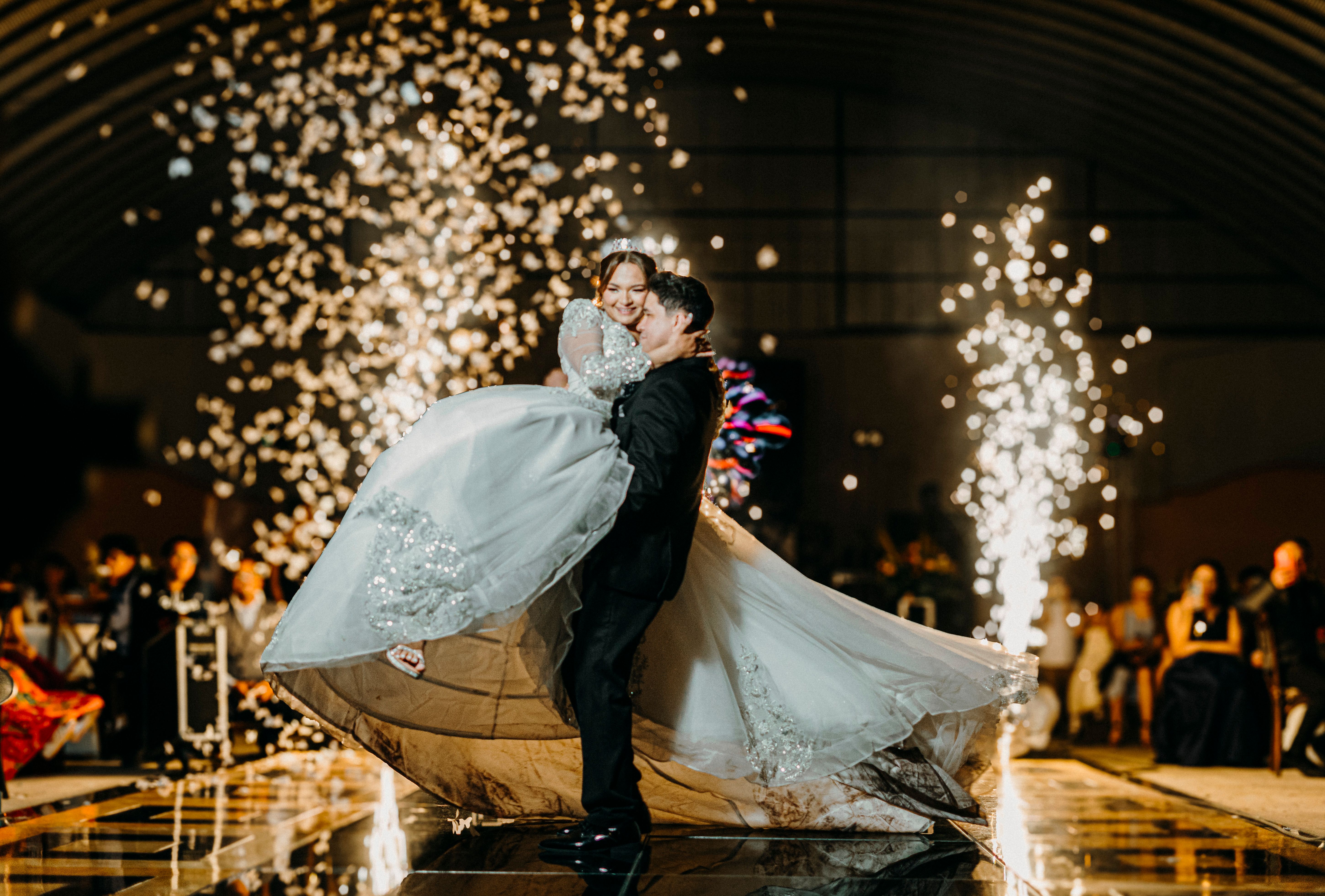 Bride and groom share a magical dance surrounded by dazzling fireworks at their wedding reception.