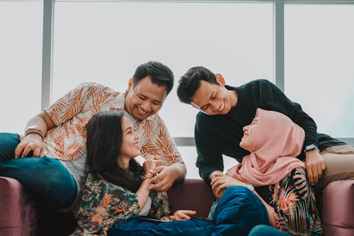 Couples Having Fun while Sitting on the Couch