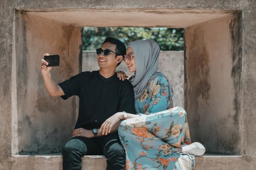 Free A Couple Taking Selfie while Wearing Sunglasses Stock Photo