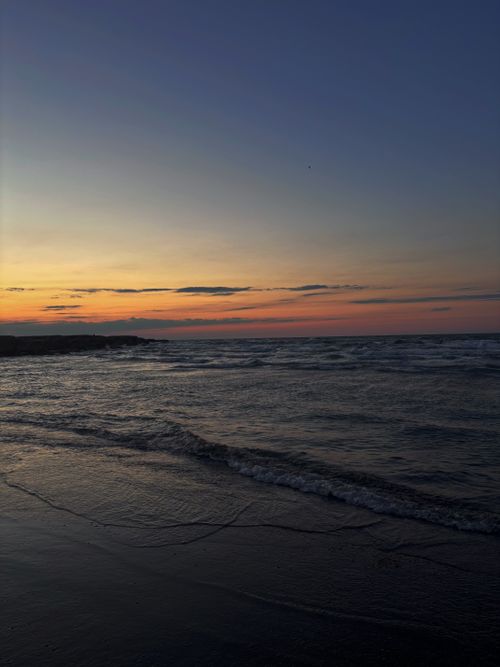 Free Peaceful sunset over the calm sea at Madīnat ash Shamāl, Qatar, with serene waves and colorful sky. Stock Photo