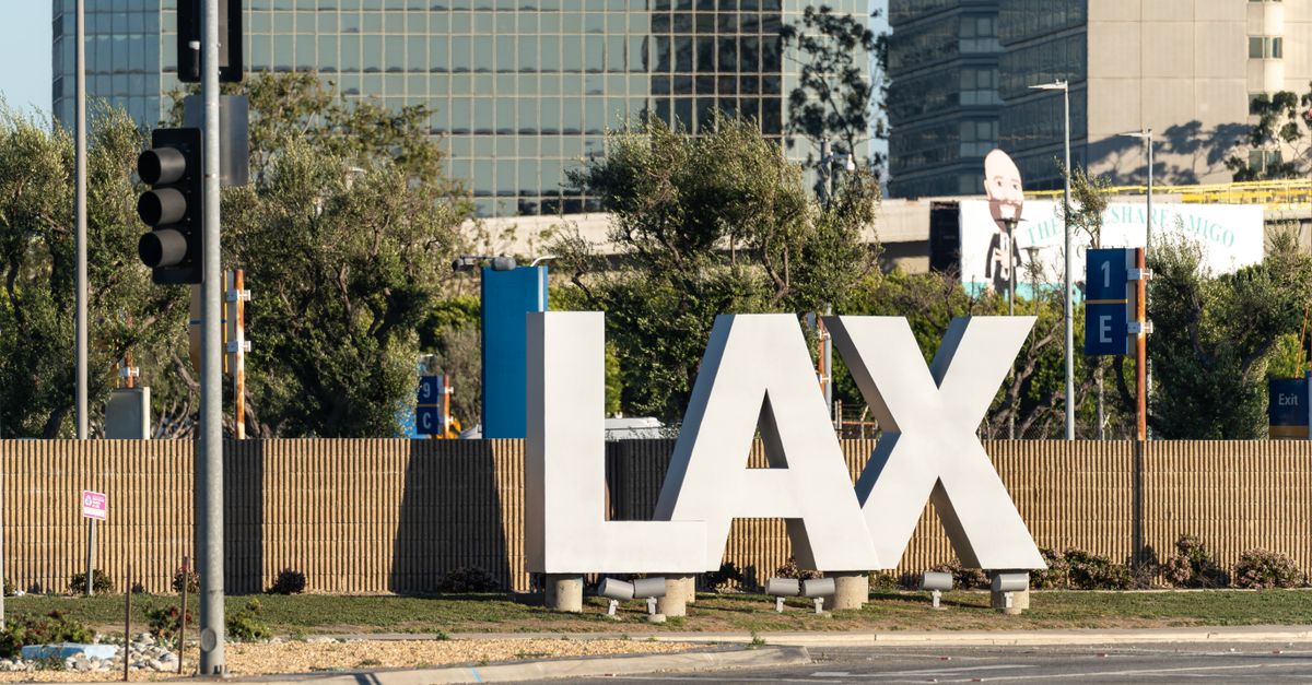 The famous LAX sign at Los Angeles International Airport on a sunny day.