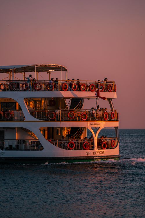 Free A serene Istanbul ferry boat at sunset with passengers enjoying the view. Stock Photo