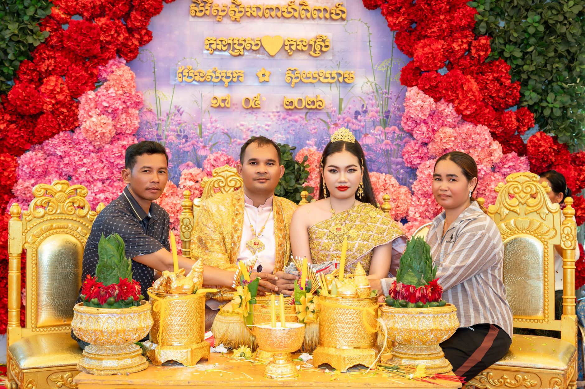 Elegant Cambodian wedding featuring traditional attire and decor.