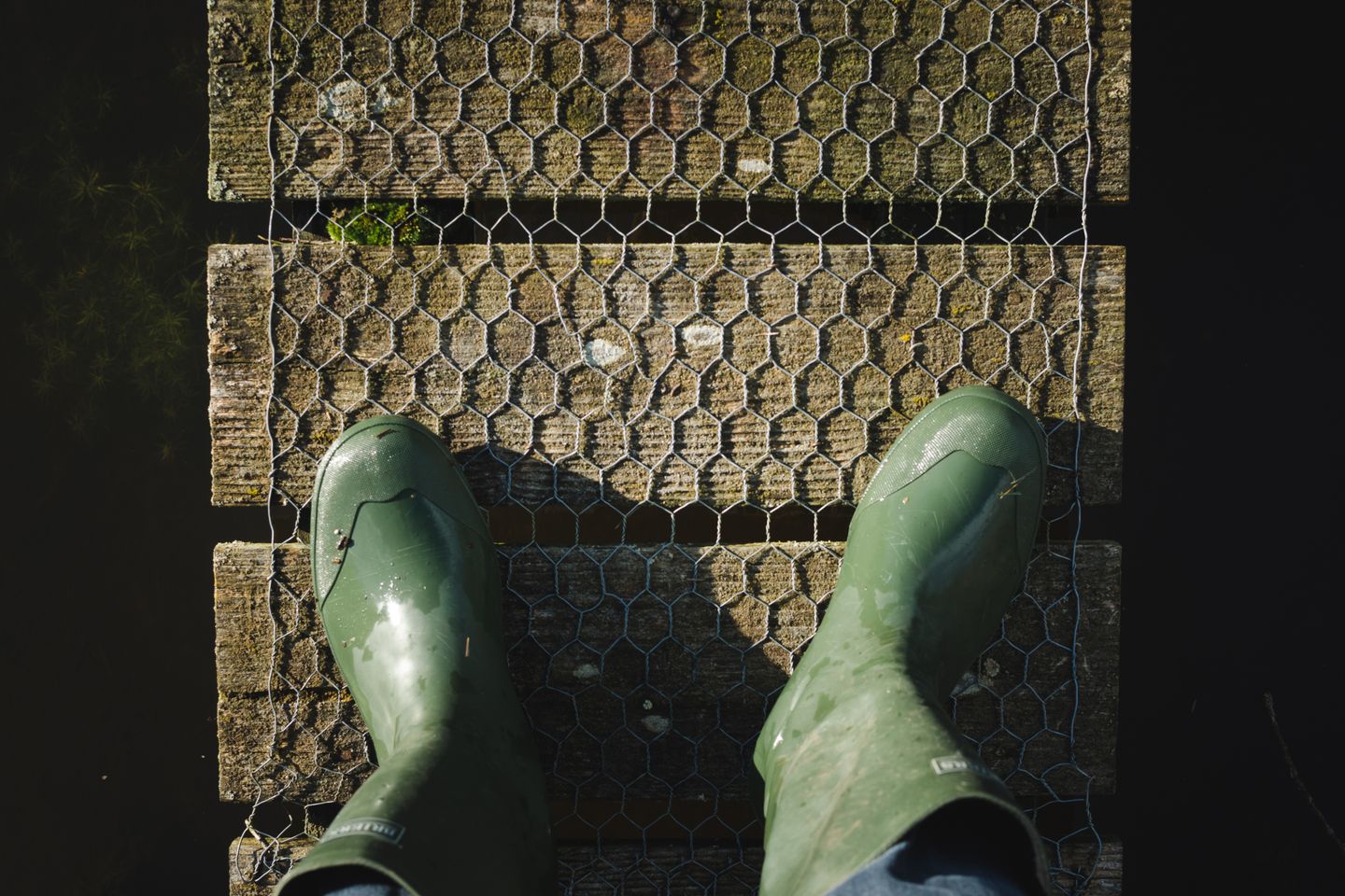 Green wellingtons on a wet grating, the sort of weather Joules was invented to sell against.