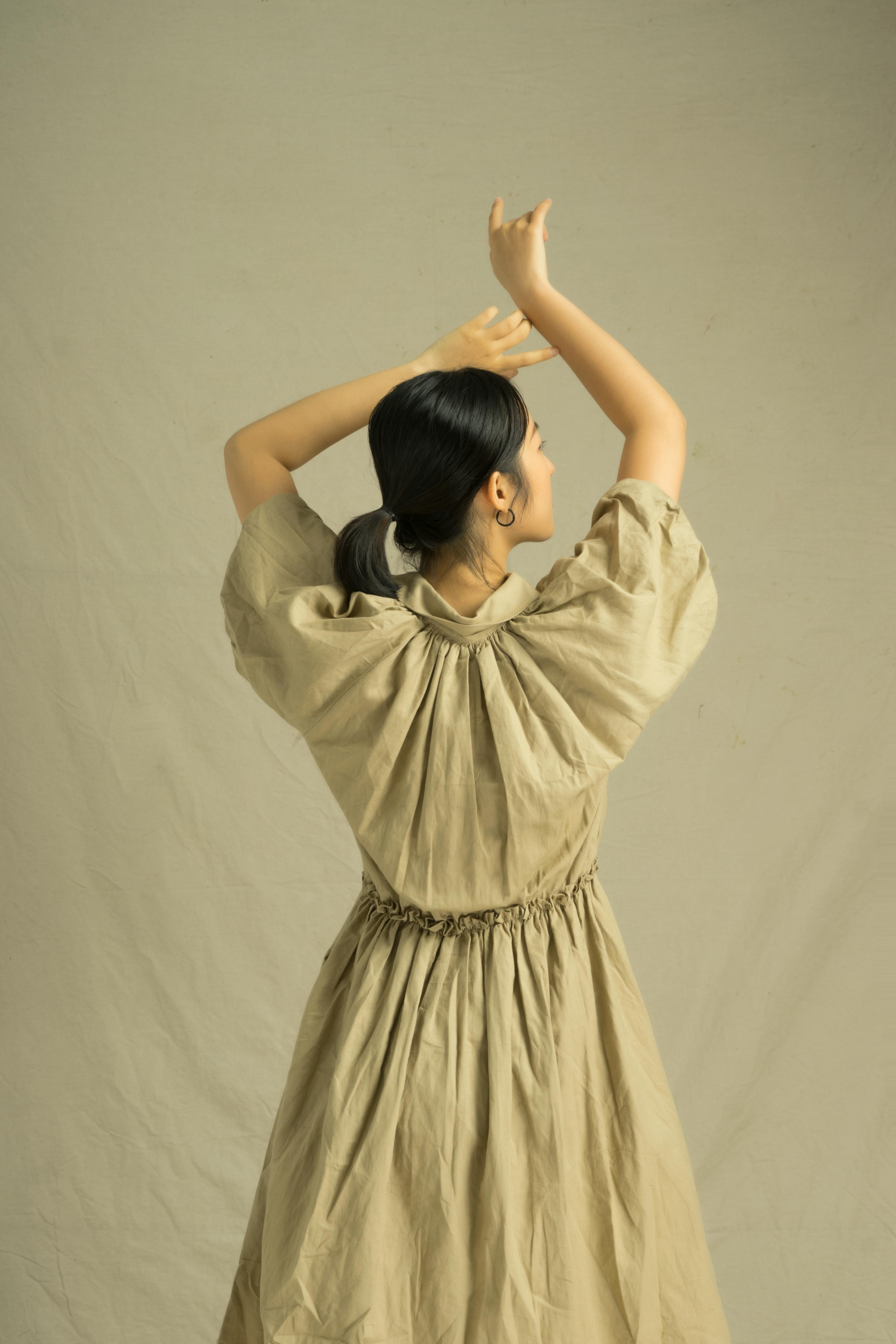 back view of a woman in brown dress