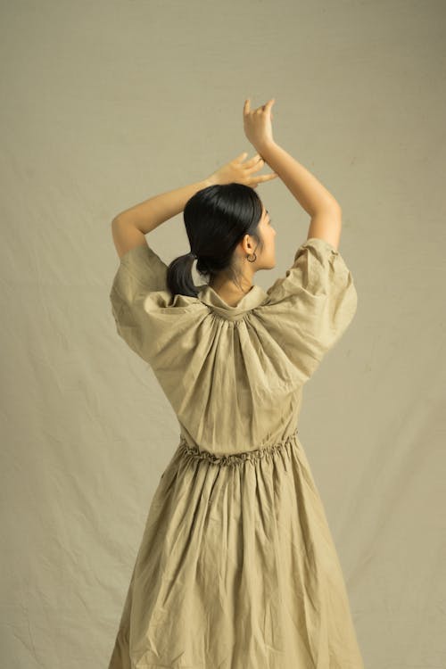 Free Back View Of A Woman in Brown Dress  Stock Photo