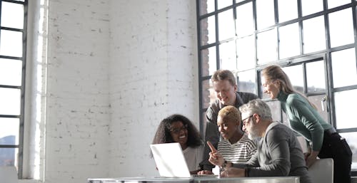 Free People Sitting at Table Using Laptop Stock Photo