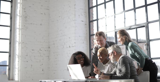 Team engaged in brainstorming session in a modern office setting.