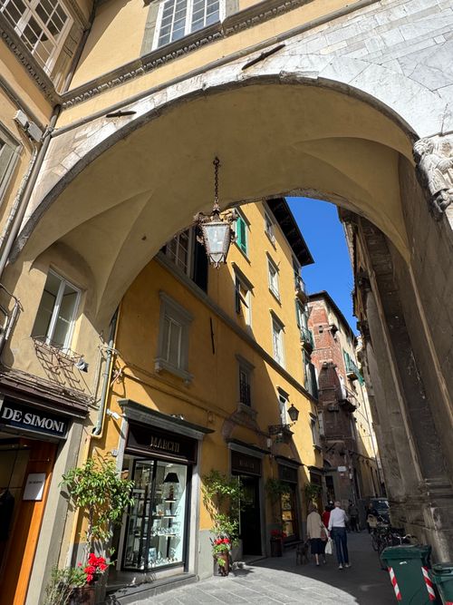 Free A charming street in Lucca, Tuscany, featuring historic architecture and vibrant shops. Stock Photo