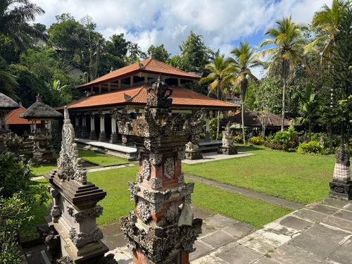 Free A serene view of traditional Balinese temple with intricate carvings and lush greenery in Bali, Indonesia. Stock Photo