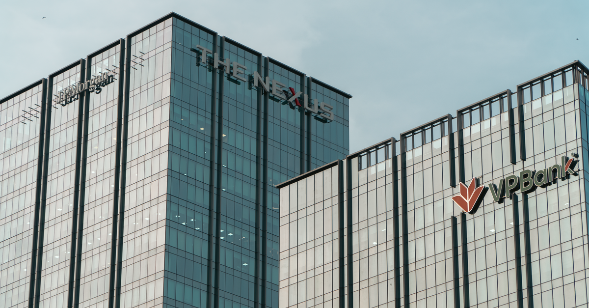 Modern glass skyscrapers featuring JP Morgan and VPBank logos in Hanoi.