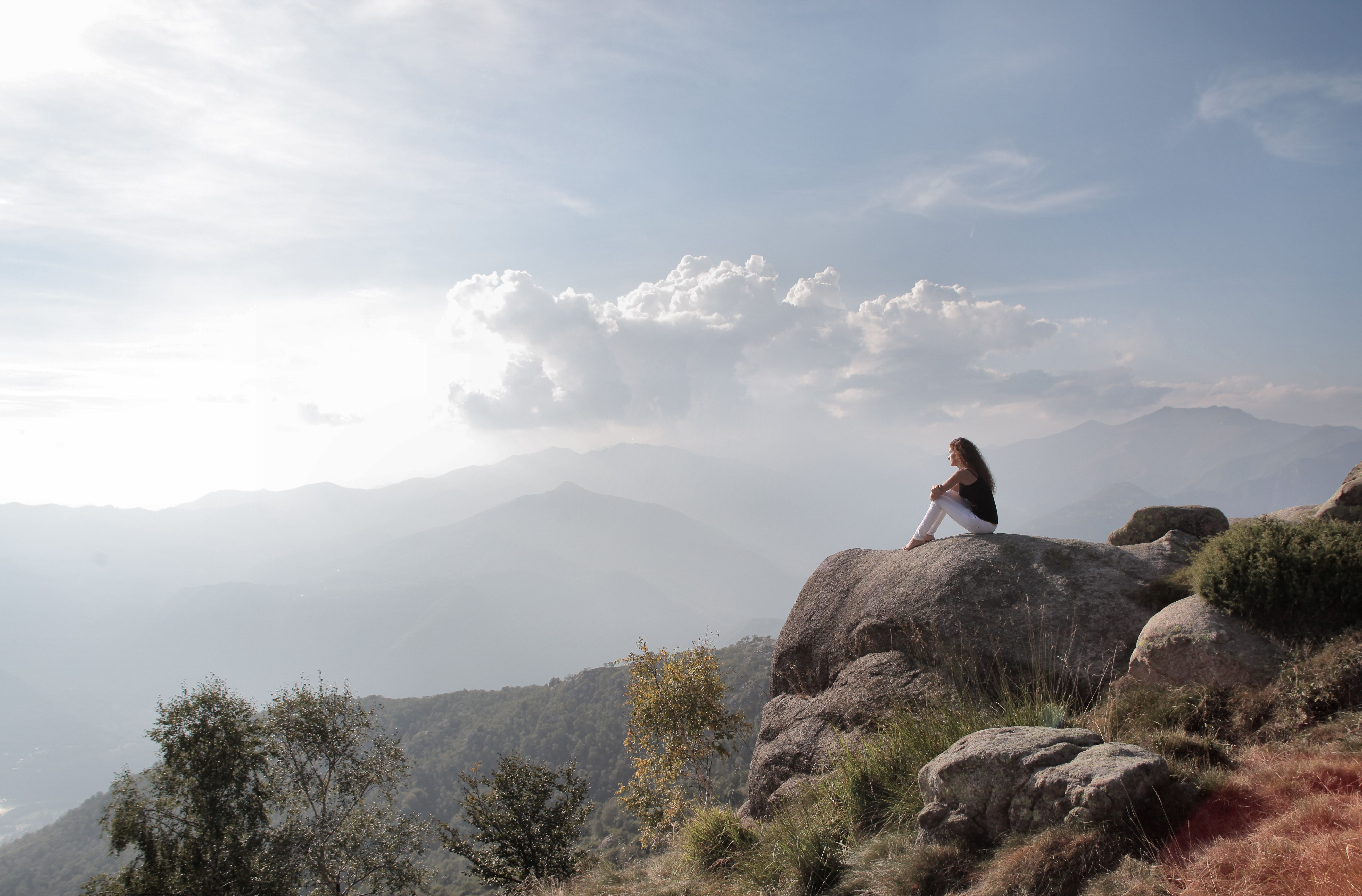 Woman Sitting On A Big Rock · Free Stock Photo