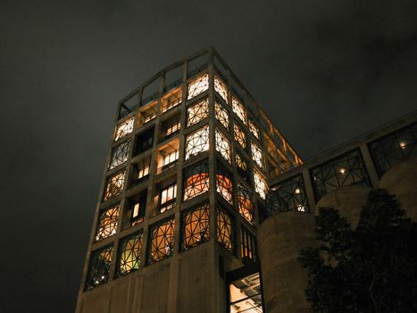 Dramatic night view of the lit-up Zeitz MOCAA building in Cape Town, South Africa.