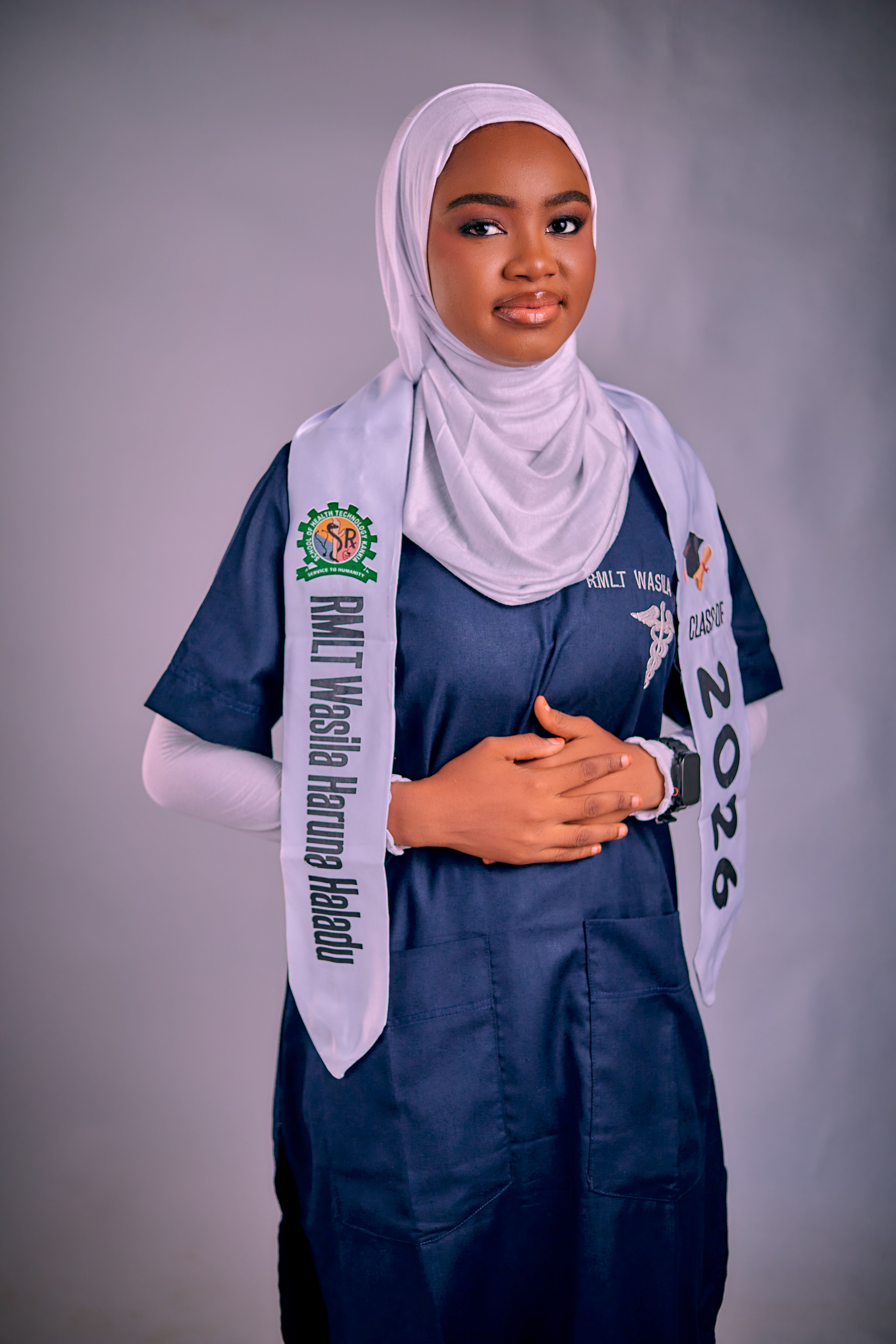 Confident young woman in graduation attire, wearing a headscarf, from Katsina, Nigeria, class of 2026.