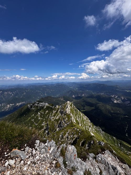Free Breathtaking panoramic view of Austrian Alps on a clear, sunny day, showcasing rocky peaks and lush valleys. Stock Photo