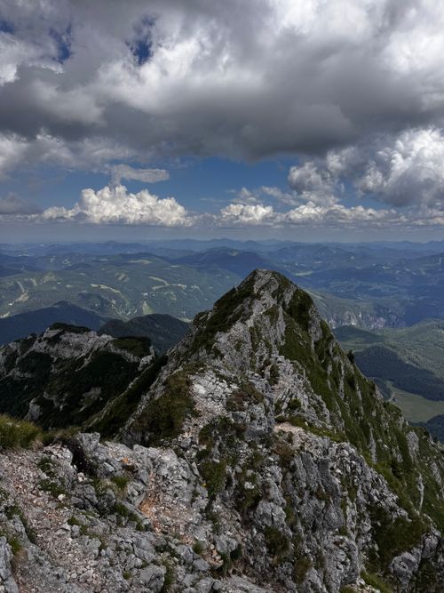 Free Elevated view of Austrian mountain peaks under a dramatic cloudy sky. Stock Photo