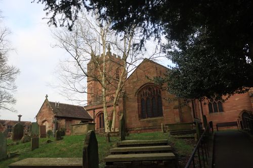 Free Old stone church with cemetery surrounded by trees in a serene spring setting. Stock Photo